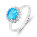 Platinum-plated ring with a round blue stone and a sparkling cubic zirconia halo