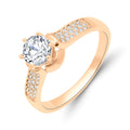 Warm gold-tone ring with a large round cubic zirconia and sparkling side rows
