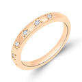 Ring with white cubic zirconia in star-shaped settings, warm gold tone