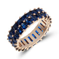 Gold-plated ring with two rows of dark blue square crystals, side view on white