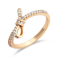 Gold-plated ring with a bow knot and a cubic zirconia path along the band