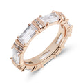 Gold-tone ring in a warm rosy shade with clear rectangular cubic zirconia all round