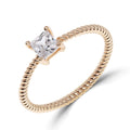 Gold-plated ring with a twisted band and a square stone in four claws