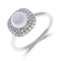 Silver-tone ring with a white pearl and a double cubic zirconia border, platinum plating