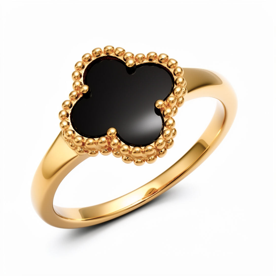 Gold-tone ring with a black enamel clover and a finely worked beaded rim