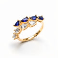 Open ring with blue and clear teardrop cubic zirconia in gold plating