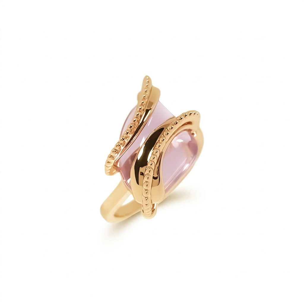 Close-up of the pink stone ring with raised beaded lines in gold plating