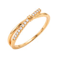 Gold-tone crossover ring with a row of white stones and a knot