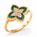 Gold-plated four-leaf clover ring with green enamel and sparkling cubic zirconia, close up