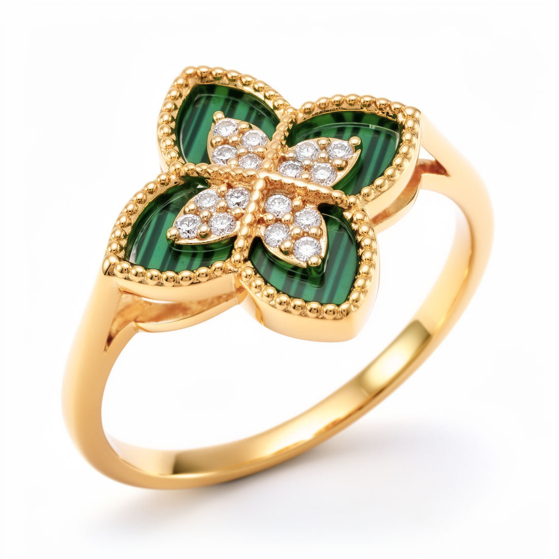 Gold-plated four-leaf clover ring with green enamel and sparkling cubic zirconia, close up