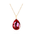 Large red teardrop crystal in a gold-plated frame on a fine chain