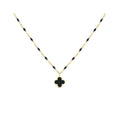 Gold-tone chain with black enamel beads and a black four-leaf clover pendant