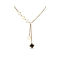 Gold-tone necklace with open clovers and a black enamel clover pendant