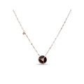 Necklace with a round black pendant and a decorative rose gold-tone chain