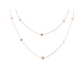 Rose gold-tone chain with small snowflakes, arranged in two loops on white