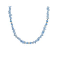 Light blue necklace of flat synthetic stones with round beads and silver-tone details