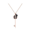 Key pendant with black clover and cubic zirconia on a long rose-tone chain