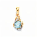 Gold-plated pendant with a faceted blue stone in an ornate scroll frame