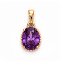 Oval violet cubic zirconia pendant in a gold-tone beaded frame on a light background