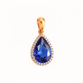 Gold-plated teardrop pendant with a deep blue cubic zirconia in a white stone halo