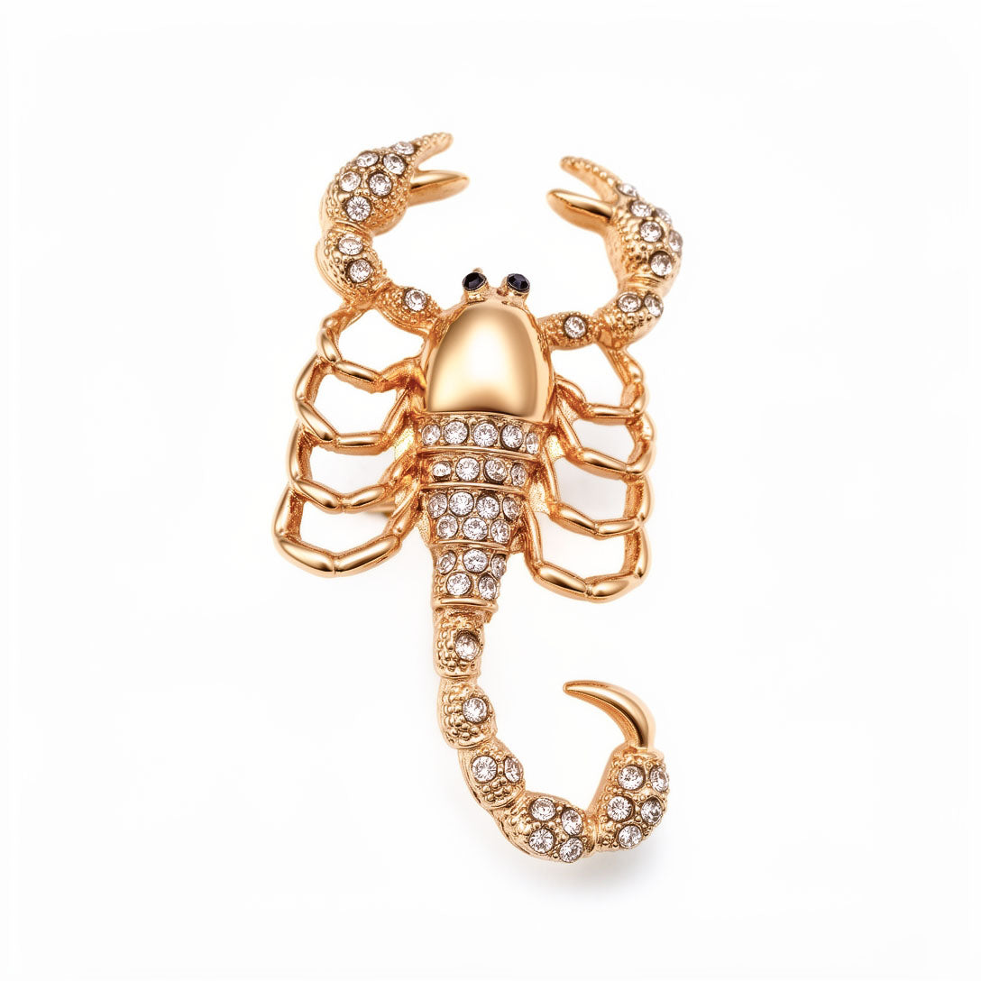 Gold-tone scorpion brooch with clear cubic zirconia on the tail and pincers