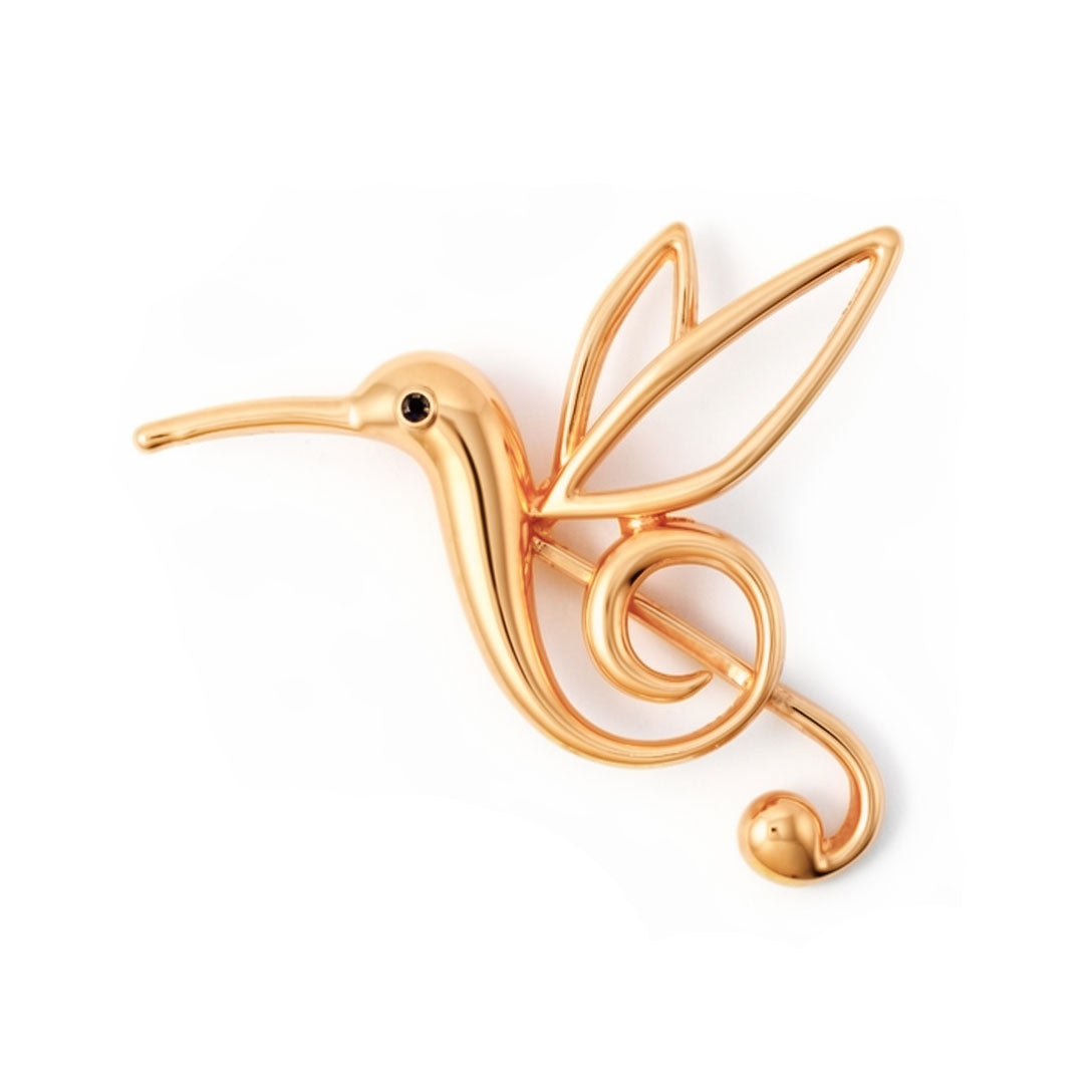 Hummingbird brooch with open wing outlines, a black eye and gold-tone finish