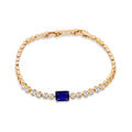 Gold-plated tennis bracelet with a rectangular dark blue stone and white cubic zirconia