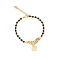 Bracelet of black faceted beads with a gold-tone chain and diamond-shaped charm