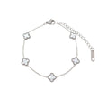 Silver-tone chain bracelet with five white enamel clovers and lobster clasp