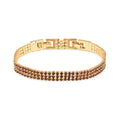 Gold-tone bracelet with two rows of dark red crystals and a secure clasp