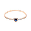 Gold-plated bangle with a blue heart-shaped stone in a cubic zirconia frame