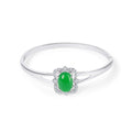 Silver-tone rigid bangle with an oval green stone in a sparkling crystal halo