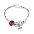 Silver-tone bracelet with a red faceted bead, blue enamel butterfly and dragonfly charm