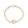 Gold-plated heart link bracelet with a filigree heart framed in cubic zirconia