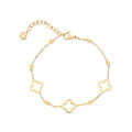 Gold-tone bracelet with three clover charms, beads and an extension chain on white