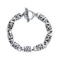 Chunky bracelet with ornamental links and a T-bar clasp
