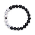 Black agate and imitation howlite stretch bracelet with a cubic zirconia spacer