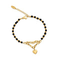 Bracelet with black faceted crystal beads, gold-plated beads and a heart charm