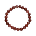 Red-brown natural aventurine bead bracelet on an elastic cord, top view